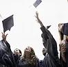 Graduates tossing caps in air 
